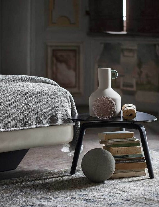 Aurora Duo bed by Poltrona Frau in Pelle Frau® leather with capitonné headboard, trapezoidal wooden base, and optional storage unit. Luxurious Italian craftsmanship. by Poltrona Frau for sale at Home Resource Modern Furniture Store Sarasota Florida