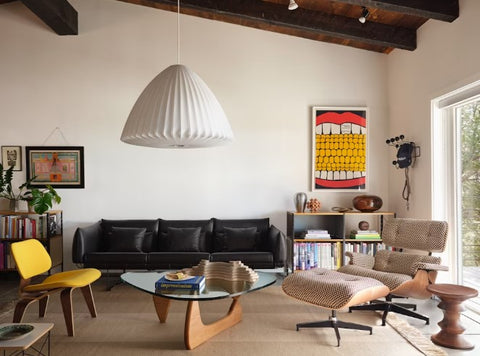 A modern and contemporary Noguchi Table by Herman Miller, featuring a sculptural wood base and freeform glass top, perfect for dining rooms or offices. Iconic design available at Home Resource of Sarasota Florida.