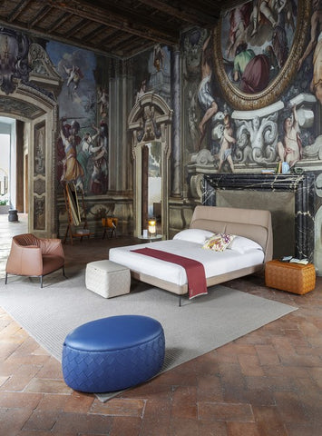 Grant collection of poufs by Poltrona Frau, featuring Pelle Frau® leather upholstery, birch plywood frame, variety of sizes and finishes, decorative belts, and steel buckles. by Poltrona Frau