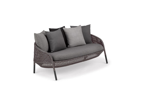Luxury outdoor AHNDA sofa by Dedon, featuring hand-made weather-resistant materials, ergonomic comfort, and modernist design. by Dedon