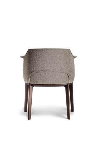 Poltrona Frau Archibald Dining Chair in fine leather, featuring elegant folds on the backrest. Luxurious Italian craftsmanship for a sophisticated dining experience.
 by Poltrona Frau