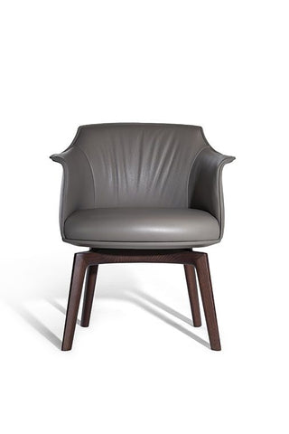 Poltrona Frau Archibald Dining Chair in fine leather, featuring elegant folds on the backrest. Luxurious Italian craftsmanship for a sophisticated dining experience.
 by Poltrona Frau