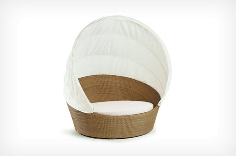 Dedon Orbit Collection, a luxury, hand-made, weather-resistant outdoor sofa with a round design and smooth-gliding casters for modern relaxation. by Dedon