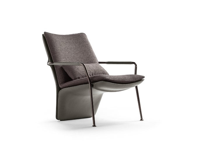 Poltrona Frau Arabesque armchair in fine leather, featuring sinuous lines and elegant design inspired by ballet. Luxurious Italian craftsmanship for sophisticated living spaces.
 by Poltrona Frau for sale at Home Resource Modern Furniture Store Sarasota Florida