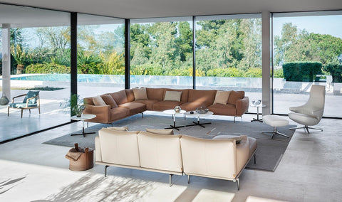 Happy Jack Sofa by Poltrona Frau, featuring soft, rounded cushions, armrests for support, curved design, modular configurations, and Pelle Frau® leather upholstery. by Poltrona Frau