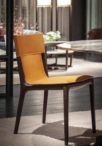 Isadora chair by Poltrona Frau, featuring fine saddle-leather upholstery, solid wood structure, and Italian craftsmanship for an elegant and sophisticated dining room. by Poltrona Frau