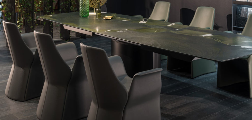 Handcrafted Draenert dining table with a natural stone top, featuring a lifting mechanism for the center plate and various base options. Available at Home Resource Sarasota. by DRAENERT for sale at Home Resource Modern Furniture Store Sarasota Florida