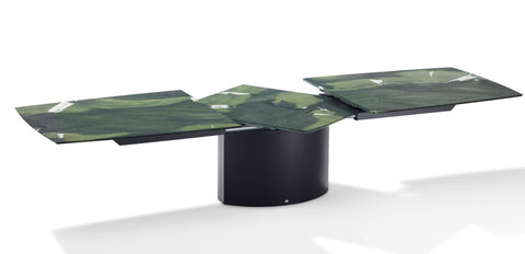 Handcrafted Draenert dining table with a natural stone top, featuring a lifting mechanism for the center plate and various base options. Available at Home Resource Sarasota. by DRAENERT