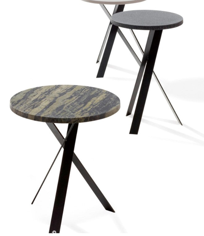 A contemporary side piece with a natural stone top featuring a leathered surface and raw edges, supported by a black steel base. Handcrafted, modern German design.
 by DRAENERT for sale at Home Resource Modern Furniture Store Sarasota Florida